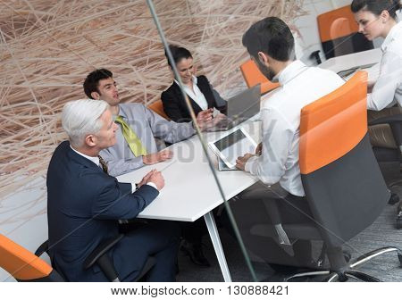 business people group brainstorming on meeting and businessman presenting ideas and projects oon laptop and tablet computer