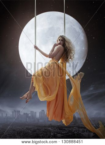 Elegant woman over big moon background
