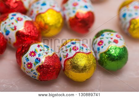 Easter chocolate little eggs andchicks covered in multicolor paper