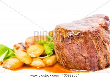 Delicious beef steak in demiglas sauce with vegetable garnish. Macro. Photo can be used as a whole background.