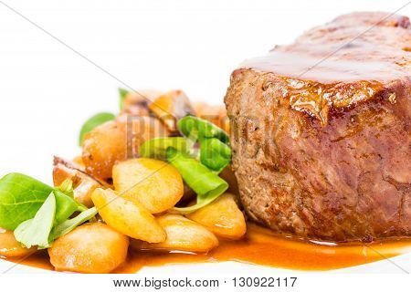 Delicious beef steak in demiglas sauce with vegetable garnish. Macro. Photo can be used as a whole background.