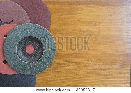 Abrasive disks for metal and stone,wood grinding, cutting. Set of abrasive materials on wooden background vertical view.