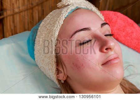 Girl with a beautician at spa salon. Beautician performs cosmetic procedures.applying cosmetic cream. Cosmetology facial beauty - The concept of facial skin care. Article about cosmetology.