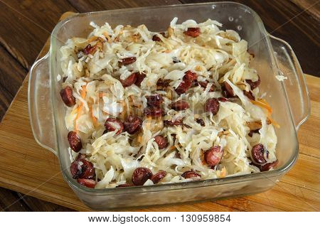 Sauerkraut with sausages on wooden table food