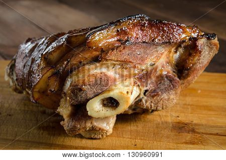 Roasted pork knuckle on the wooden table