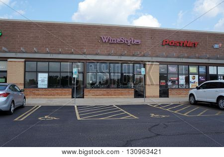SHOREWOOD, ILLINOIS / UNITED STATES - AUGUST 16, 2015: One may purchase wine at Wine Styles, and ship packages at Post Net, in a strip mall in Shorewood.