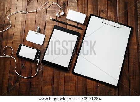 Photo of blank corporate identity template wooden table background. Template for branding identity. Blank stationery mock-up for designers portfolios. Top view.