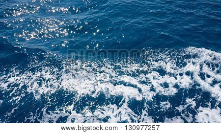 Restless foamy blue sea water with splash