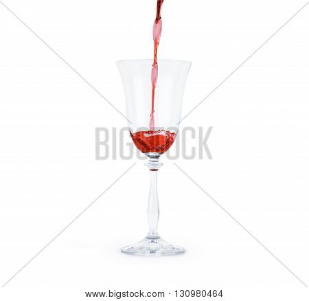Red wine poured in a glass isolated on white