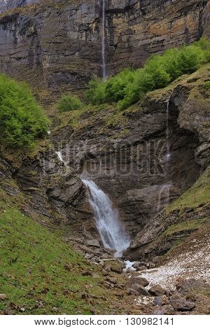 Spring scene in the Swiss Alps. Waterfall in Glarus Canton Kloental valley.