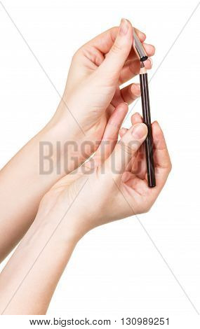 The black eyebrow pencil in the hands of women isolated on white background.