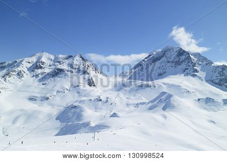 Alpine resort of Les Arcs with ski slopes on snowy French Alps mountains