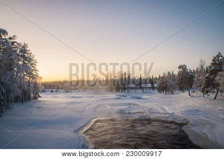 Half Frozen Raudanjoki Peat River On A Winter Day, Vaattunki, Finland.