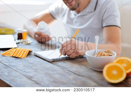 Tips For Biohacking. Selective Focus Of Thin Notebook While Male Hand Noting Data And Biohacking Sup