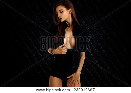 Horizontal Portrait Of Beautiful Sexual Woman In Black Shorts And A Jacket Is Isolated On A White Ba