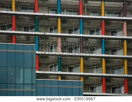Balconies Of The Skyscraper With Colored Columns. Modern Building With Panoramic Windows