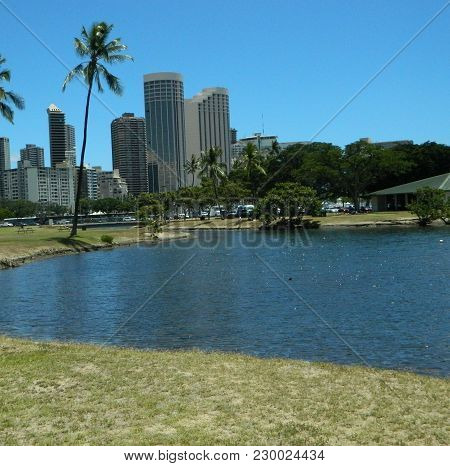 Hawaii Skyline Behind Park On A Clear Day On A Lake