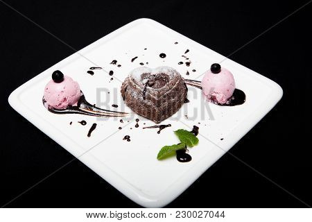 Dessert Fondan Chocolate With Ice-cream On A White Plate On A Black Background. Exquisite French Cho