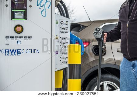 Limburg , Germany - February 11 2018 : Man Charging His Electric Car In The Winter