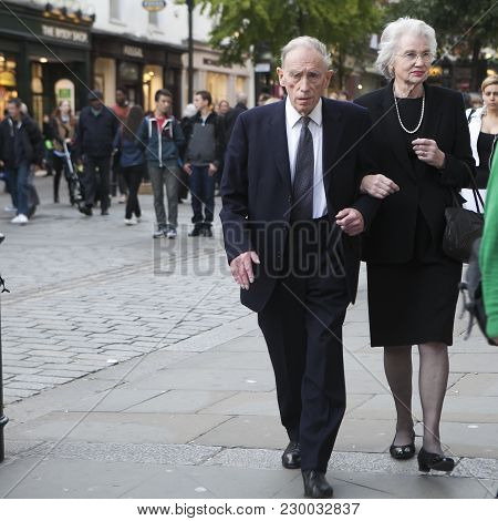 London, England - July 12, 2016 An Elderly Serious Couple Goes To The Theater At Covent Garden
