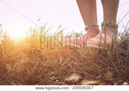 Detail Of A Young Woman's Shoes And Anklet Outdoors.