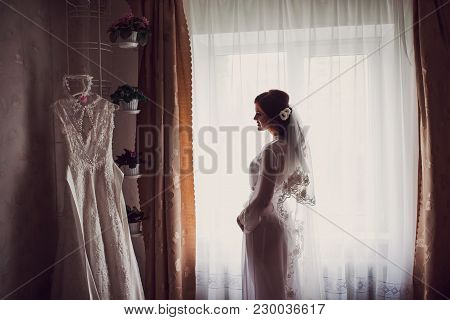 Night Wedding Ceremony. The Bride And Groom Hugging On Sea Pier