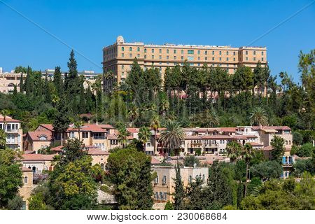 View of the houses of Yemin Moshe neighborhood under blue sky in Jerusalem, Israel.