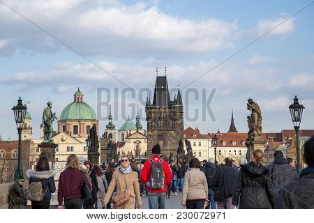 Prague, Czech Republic - March 16, 2017: People Walking On The Damous Charles Bridge In The City Cen