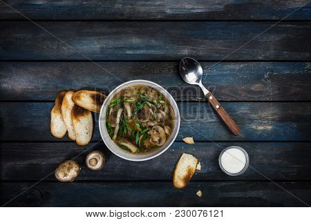 Fresh Mushroom Soup With Green Onion Sour Cream And Bread Crisps. In White Bowl Dishe And Cutlery. C