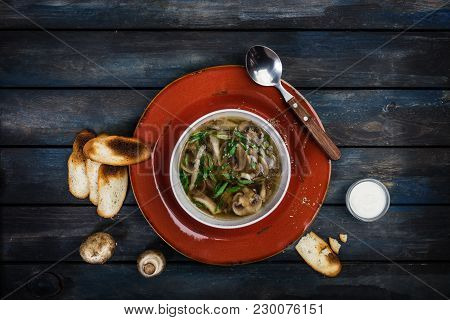 Fresh Mushroom Soup With Green Onion Sour Cream And Bread Crisps. On A Ceramic Plate With A Spoon. C