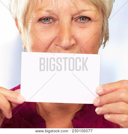 Senior Woman With Manifying Glass Showing Teeth, Background