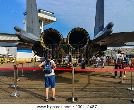 Singapore - Feb 10, 2018. A Man Looking At A Mcdonnell Douglas F-15e Strike Eagle Fighter Aircraft O