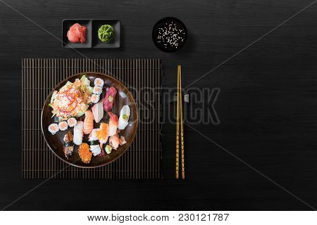 Sushi Set Nigiri, Sushi Rolls And Sashimi On Black Background