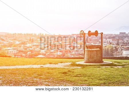 Retro Old Well On The Background Of The City Panorama. Kutaisi, Georgia. Europe. Travels. Nature. Su