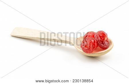 Red Dry Cherries In A Wooden Spoon Isolated On White Background