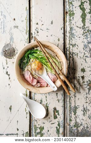 Asian Dish Udon Noodles With Egg Yolk, Sesame, Mushrooms, Boc Choy, Sliced Sous Vide Cooked Meat Ser