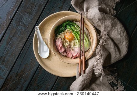 Asian Dish Udon Noodles With Egg Yolk, Sesame, Mushrooms, Boc Choy, Sliced Sous Vide Cooked Meat Ser