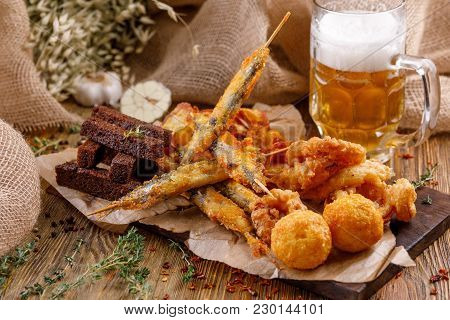 Snacks To A Beer Plate. Still-life On A Wooden Background.