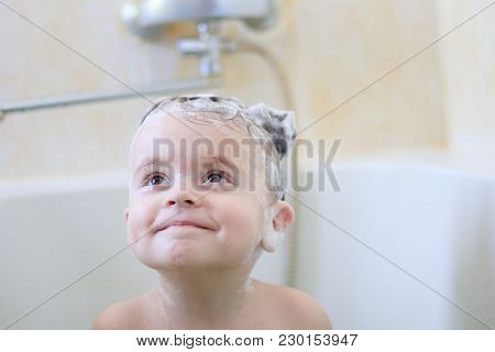 Cute Little Girl Washes Her Hair With Shampoo