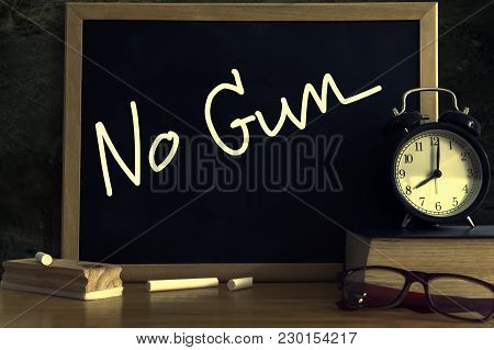 Text 'No Gun' on the black board. Social problems in school.
