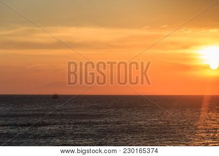 Vietnamese Fishing Boat Silhouettes In Sea At Sunset