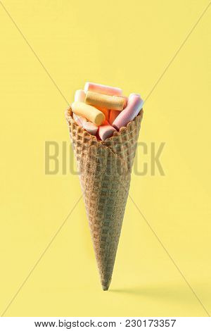 Pink And Yellow Marshmallows In Waffle Cone On Light Yellow Background. Top View, Flat Lay. Free Spa