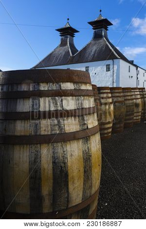 Traditional White Painted Building With Black Double Tower Roof Of Scottish Whisky Distillery.