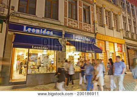 Brussels - May 25: Unidentified Tourists Visiting The Famous Chocolate Store Leonidas, In The Histor