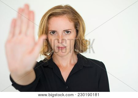 Serious Unsmiling Woman Showing Stop Gesture And Looking At Camera. Displeased Lady Boss Rejecting Y