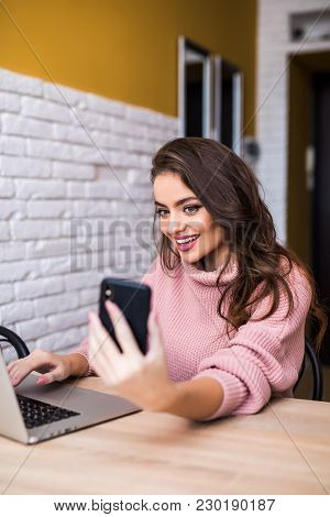 Beautiful Girl Smile Using Multiple Devices Phone And Laptop On A Table At Home