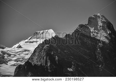 Black And White Photo Of Eiger In Black And Mönch In White, Contrasting Against Each Other (swiss Al