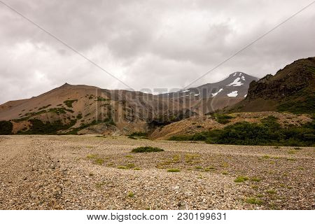 Icelandic Landscape With Red Hills In Lonsoraefi In Cloudy Weather