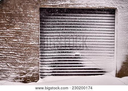 Front Garage Entrance Covered In Light Snow.