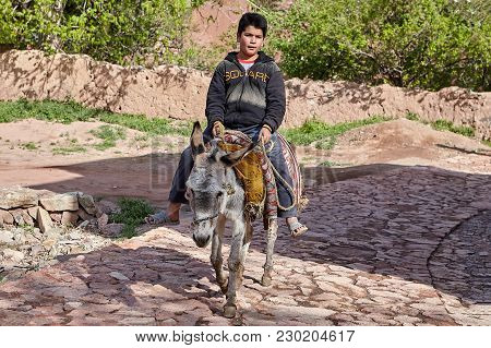 Abyaneh, Iran - April 26, 2017: Iranian Boy Is Riding On A Donkey In The  Traditional Village In The